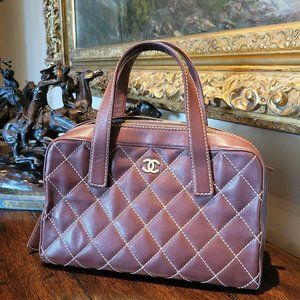 CHANEL Leather Wild Stitch Matrasse
Coco Mark Handbag In a rust brown color.